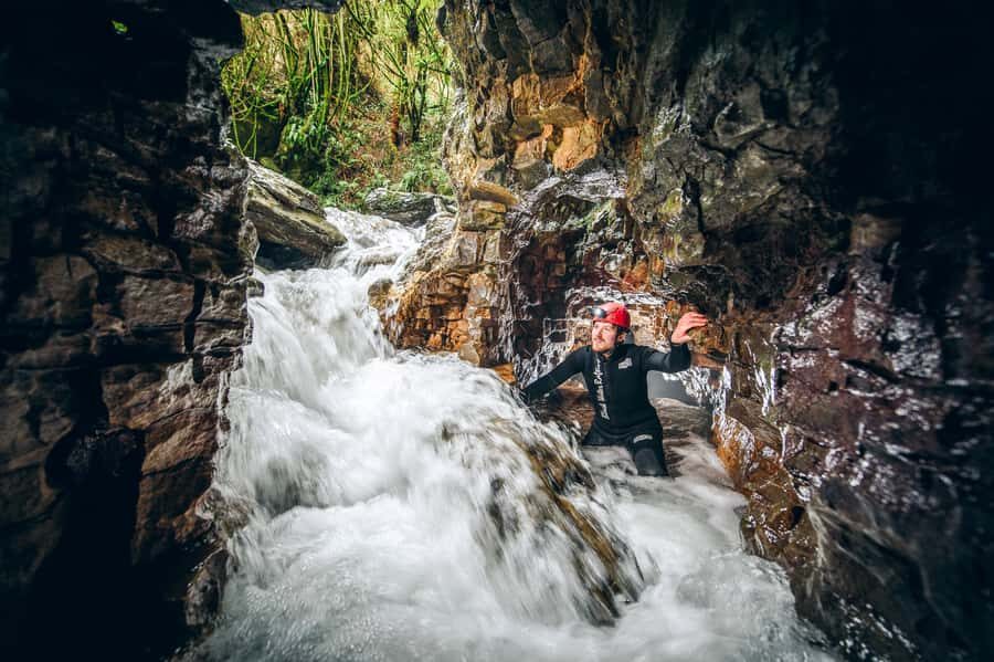Waitomo Caves Black Abyss Ultimate Caving Experience - Climbing underground waterfalls: the muddy workout part